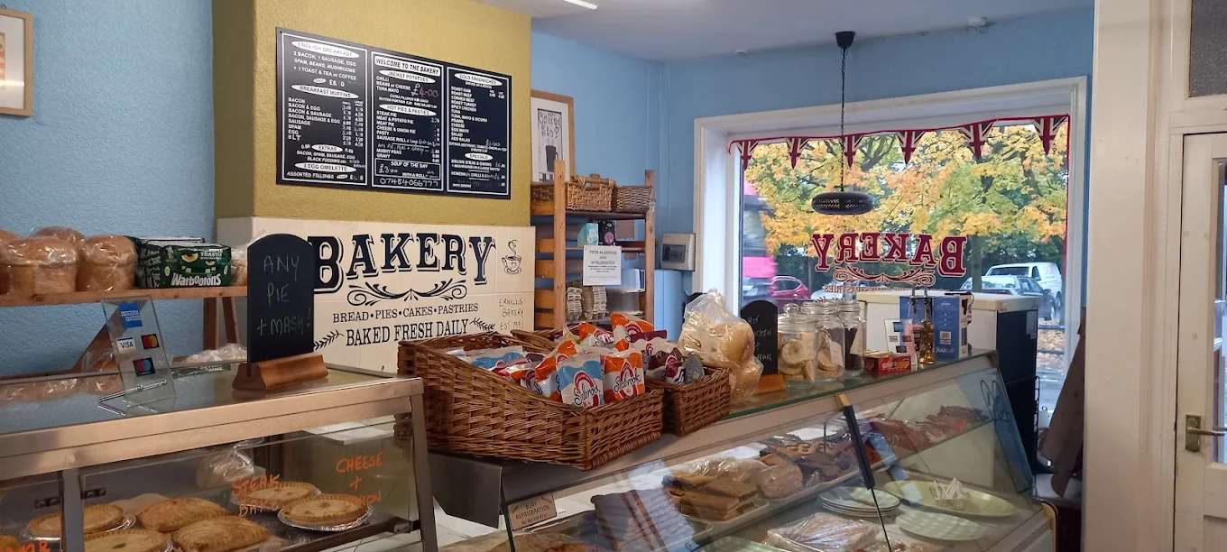 Serving area with tiled bakery sign and blackboard menus