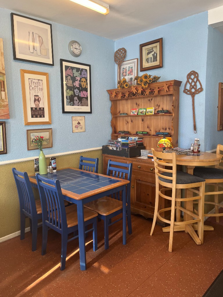 Traditionally furnished seating with blue tiled table and high stools
