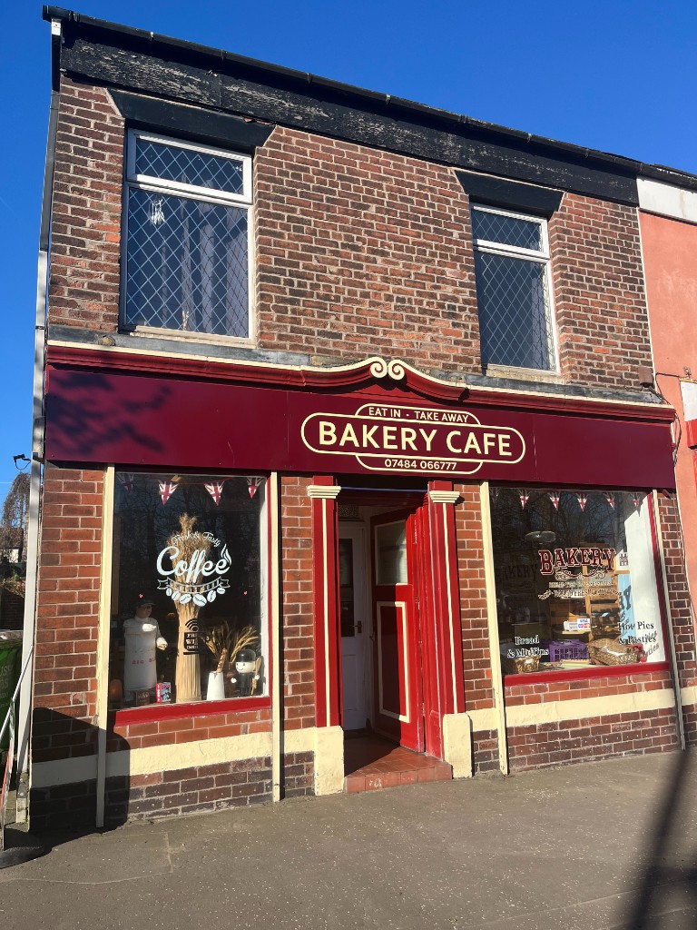 The Bakery Cafe shop front on Manchester Street, Heywood, opposite the East Lancashire Railway station