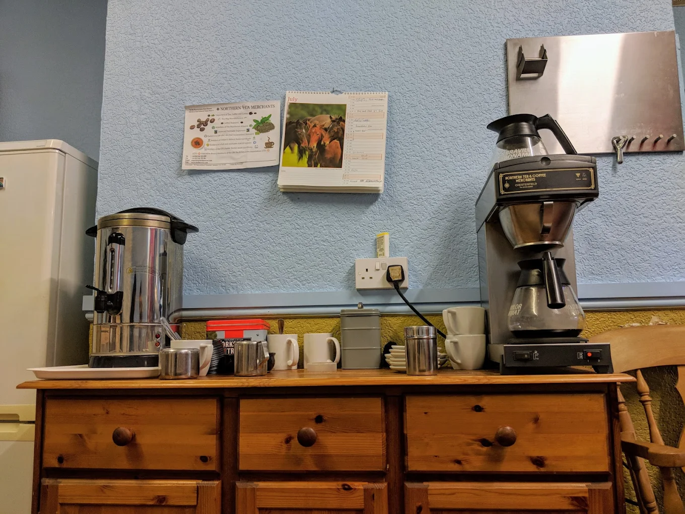 Cosy cafe seating with flowers and coffee menu on the table