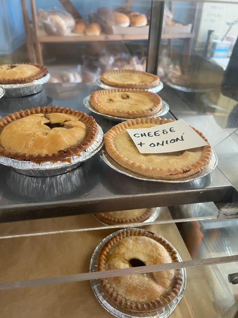 Golden cheese and onion pies in the display case at The Bakery Cafe